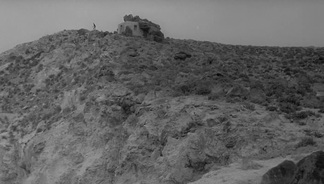 Still of a distant figure on the island’s horizon from Antonioni’s L’avventura