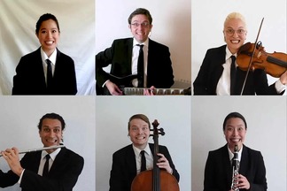 Six musicians wearing black ties and suits, holding their instruments and grimacing.