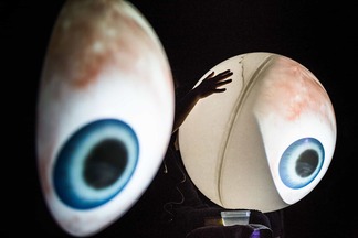 Two enormous eyeballs projected onto balloons are performed as part of Carola Bauckholt’s piece “Oh, I see”